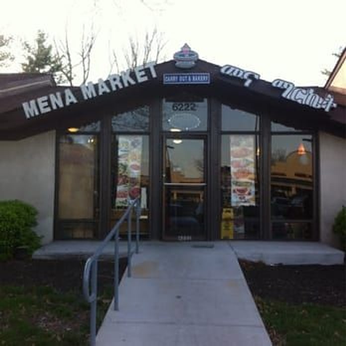 The Mena storefront on Rolling Rd: a brown A-frame entrance with a ramp up to glass doors.